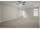 Bright bedroom features neutral paint, carpet, tray ceiling, and a ceiling fan at 3649 Salem Glen Rd, Lithonia, GA 30038