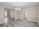 Open concept dining room with wood-look floors and a chandelier at 3649 Salem Glen Rd, Lithonia, GA 30038