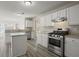 Modern kitchen featuring white cabinets, stainless steel appliances, and granite countertops at 3649 Salem Glen Rd, Lithonia, GA 30038