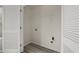 Small laundry room featuring wood-look flooring and white shelving at 3649 Salem Glen Rd, Lithonia, GA 30038