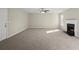 Spacious living room featuring plush carpeting, neutral walls, and a cozy fireplace at 3649 Salem Glen Rd, Lithonia, GA 30038