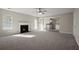 Bright living room with a fireplace, ceiling fan and an open view of the kitchen at 3649 Salem Glen Rd, Lithonia, GA 30038