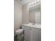 Powder room featuring a vanity with a sink, a large mirror and a toilet at 3649 Salem Glen Rd, Lithonia, GA 30038