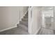 Carpeted stairs leading to the second floor, with an open view of the kitchen at 3649 Salem Glen Rd, Lithonia, GA 30038