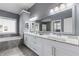 Bright main bathroom with double sink vanity, large mirror, soaking tub, and granite counters at 4160 Tilly Mill Rd, Atlanta, GA 30360