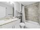 This bathroom includes a shower-tub, granite sink, and metal shelving at 4160 Tilly Mill Rd, Atlanta, GA 30360