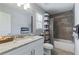 Bright bathroom with tub/shower, tiled walls, and single sink vanity at 4160 Tilly Mill Rd, Atlanta, GA 30360