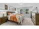 This bedroom includes a comfortable bed, bedside table, and bureau at 4160 Tilly Mill Rd, Atlanta, GA 30360