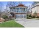 Charming two-story home with blue siding, stone accents, and a well-manicured front yard at 4160 Tilly Mill Rd, Atlanta, GA 30360