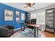 Stylish home office featuring blue accent wall, wooden desk and natural light at 4160 Tilly Mill Rd, Atlanta, GA 30360