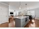 This kitchen has an island with stainless steel appliances and a view of the living room at 4160 Tilly Mill Rd, Atlanta, GA 30360