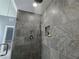 Walk-in shower with tile surround, shower niche and brushed-nickel hardware at 4160 Tilly Mill Rd, Atlanta, GA 30360