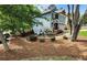 The home has a side yard with beautiful landscaping with lots of mature trees at 4160 Tilly Mill Rd, Atlanta, GA 30360