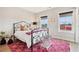 Comfortable bedroom with geometric rug, iron bed frame and natural light from two windows at 4308 Southside Dr, Acworth, GA 30101