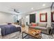 A bedroom features a bed, ceiling fan, grey couch and modern coffee table at 4308 Southside Dr, Acworth, GA 30101