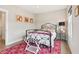 Bedroom with an ornate metal bed frame and a colorful geometric rug on hardwood floors at 4308 Southside Dr, Acworth, GA 30101