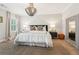 Bright main bedroom with plush bedding, a large mirror, and a modern chandelier at 4308 Southside Dr, Acworth, GA 30101