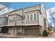 Rear exterior view of tan townhomes with attached garages, covered patios and upper-level balconies at 4308 Southside Dr, Acworth, GA 30101