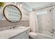 Bathroom featuring a marble vanity, an oval mirror, and a shower with a marble tile surround at 4742 Balmoral Ne Way, Marietta, GA 30068