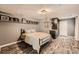 Cozy bedroom with wood plank floors, a bed, and a sink area with shelving at 4742 Balmoral Ne Way, Marietta, GA 30068