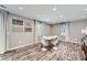 Basement dining room with white chairs, a white table, wood plank floors, and a window providing natural light at 4742 Balmoral Ne Way, Marietta, GA 30068