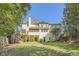 Back of house featuring a deck, patio, and a spacious lawn at 4742 Balmoral Ne Way, Marietta, GA 30068