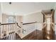 Hallway with hardwood flooring, white trim, crown molding, and a chandelier hanging from the ceiling at 4742 Balmoral Ne Way, Marietta, GA 30068