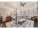 Spacious main bedroom with a tray ceiling, hardwood floors, and a four-poster bed at 4742 Balmoral Ne Way, Marietta, GA 30068