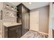 Mud room featuring a modern sink, black cabinetry, and stylish wallpaper at 4742 Balmoral Ne Way, Marietta, GA 30068