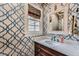 Chic powder room showcasing patterned wallpaper, a marble countertop, and a decorative mirror at 4742 Balmoral Ne Way, Marietta, GA 30068