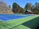 Brightly colored tennis courts with an outdoor covered seating area provide a fun community activity at 4742 Balmoral Ne Way, Marietta, GA 30068