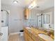 Well-lit bathroom with a double vanity, granite countertops, and a glass-enclosed shower at 799 Hammond Dr # 219, Atlanta, GA 30328