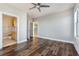 Inviting bedroom showcases dark hardwood floors, a ceiling fan, and ensuite bathroom access at 799 Hammond Dr # 219, Atlanta, GA 30328