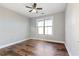 Bright bedroom featuring wood floors, a ceiling fan, and a large window at 799 Hammond Dr # 219, Atlanta, GA 30328