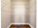 Walk-in closet featuring a custom shelving system and wood flooring at 799 Hammond Dr # 219, Atlanta, GA 30328