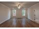 Spacious bedroom featuring hardwood floors and ample natural light at 133 Ward'S Crossing Way # 18, Johns Creek, GA 30022