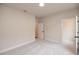 Carpeted room with closet, neutral walls, and white trim and doors at 133 Ward'S Crossing Way # 18, Johns Creek, GA 30022