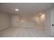 An open bonus room features neutral walls, carpet, and multiple doors at 133 Ward'S Crossing Way # 18, Johns Creek, GA 30022