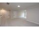 An open bonus room features neutral walls, carpet, and multiple doors at 133 Ward'S Crossing Way # 18, Johns Creek, GA 30022