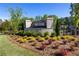 Well-maintained community entrance featuring brick signage, manicured landscaping, and lush greenery at 133 Ward'S Crossing Way # 18, Johns Creek, GA 30022