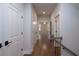 Hallway featuring white doors and hardwood floors at 133 Ward'S Crossing Way # 18, Johns Creek, GA 30022