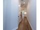 Narrow hallway with wood floors, white walls, and recessed lighting leading to staircase at 133 Ward'S Crossing Way # 18, Johns Creek, GA 30022