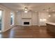 Bright living room with a stone fireplace, hardwood floors, and large windows at 133 Ward'S Crossing Way # 18, Johns Creek, GA 30022