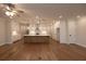 Modern living room with hardwood floors, a kitchen island, and sleek, white cabinetry at 133 Ward'S Crossing Way # 18, Johns Creek, GA 30022