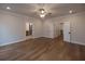Spacious main bedroom featuring wood floors, a ceiling fan, and access to the bathroom at 133 Ward'S Crossing Way # 18, Johns Creek, GA 30022
