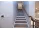 Staircase with hardwood steps, a white risers, and a wooden handrail at 133 Ward'S Crossing Way # 18, Johns Creek, GA 30022