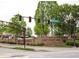 Johns Creek Walk street view featuring lush greenery and a brick sign at 133 Ward'S Crossing Way # 18, Johns Creek, GA 30022