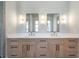 Bathroom boasts double vanity with light wood cabinets, modern hardware, and large mirrors at 145 Cedarwood Ln, Roswell, GA 30075