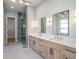 Bright bathroom featuring double vanity, modern fixtures, glass shower, and beautiful tile work at 145 Cedarwood Ln, Roswell, GA 30075