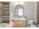 Beautiful bathroom featuring open shelves, a vanity, and an arched mirror at 145 Cedarwood Ln, Roswell, GA 30075